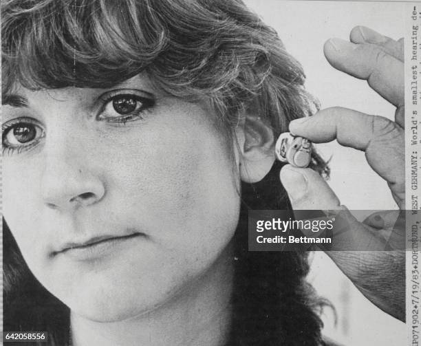 Dortmund, West Germany: World's smallest hearing device, handmade from individual ear prints for insertion into the auditory canal, is smaller than a...