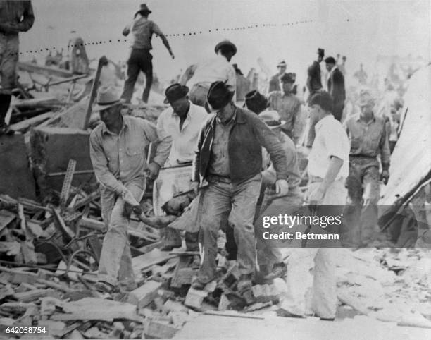 Rescue workers as they were removing the victims of the frightful school blast at New London, Texas, from the ruins of the building.