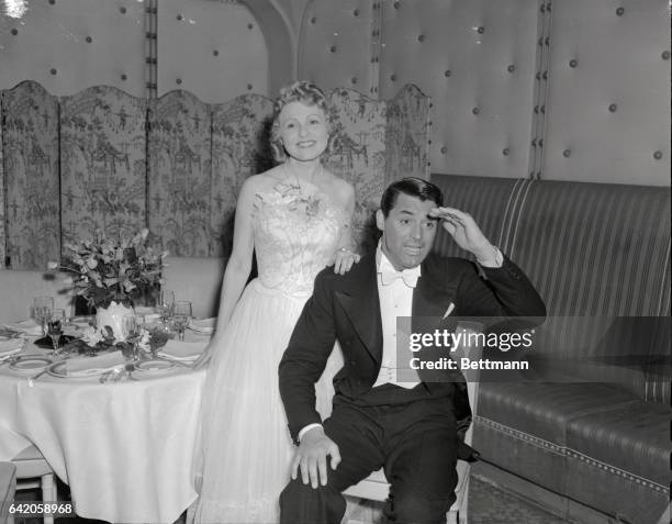 Mrs. Hal Roach, wife of the producer, and Cary Grant, actor, pictured at the Los Angeles Turf Club Ball, held at the Biltmore Hotel.