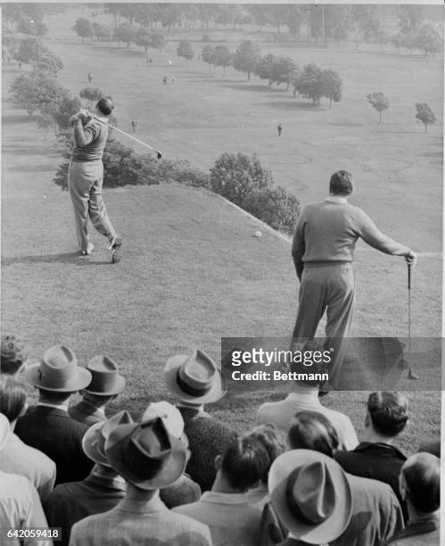 Veteran Vic Ghezzi drives a long one, with contender for the play, Harold McSpaden, looking on at the $13,333 Los Angeles Open Golf Tournament at the...