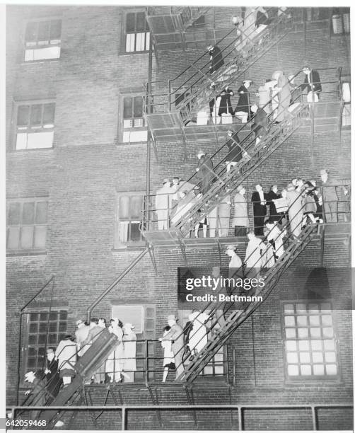 Chicago: Guests Leave Burning Hotel. Some of the 1100 persons who were staying in the LaSalle Hotel when an early morning fire broke out, swarm down...