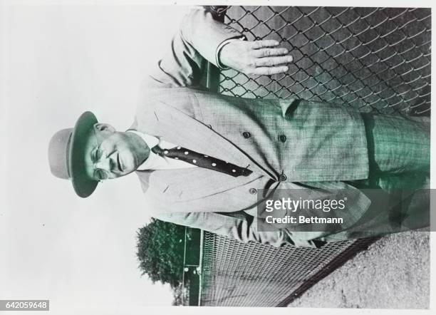 Forest Hills, NY: John Foster Dulles, Secretary of State under Eisenhower. Photograph of him leaning against a fence at the West Side Tennis Club,...