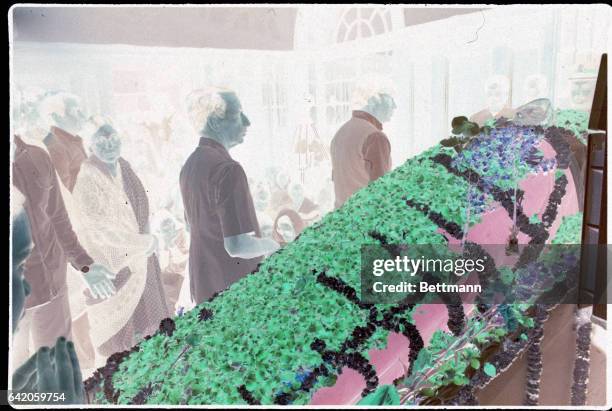 New Delhi-ORIGNIAL CAPTION READS: The late Prime Minister Indira Gandhi lies in state, as mourners arrange flowers. Mrs. Gandhi's body will be...