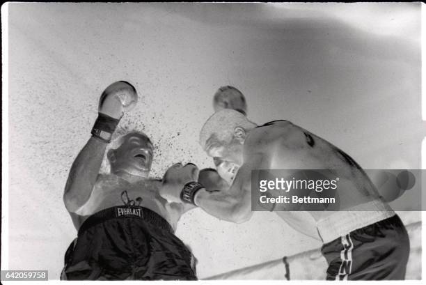 Atlantic City, NJ- Michael Spinks slams a hard left to Jerry Cooney, sending him flying during third round action of their "War at the Shore" match...