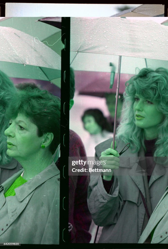 Fawn Hall and Peggy Say Standing under Umbrella