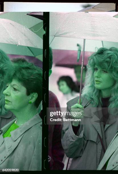 Fawn Hall holds an umbrella as she and Peggy Say, sister of the American hostage Terry Anderson, attend a 40th birthday salute for Anderson at the...