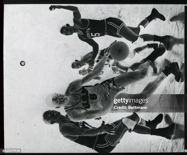 Billy Russel of the University of San Francisco, does some fancy dribbling as he tries to get away from Leo Carney and Bob Hodson , both of Wichita...