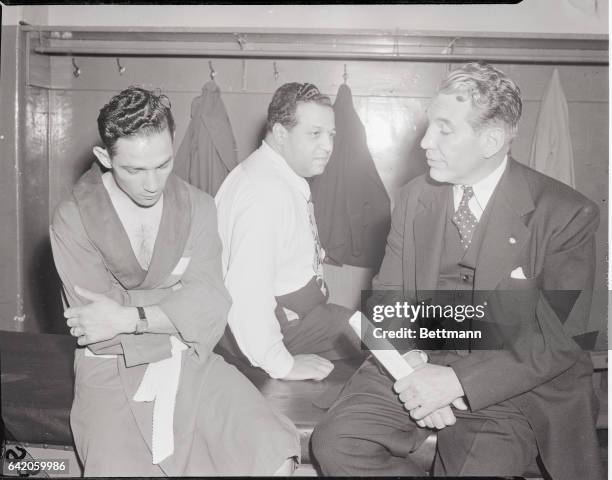 Photo shows, left to right: Willie Pep, his manager Lou Viscusi and Colonel Bill Eagan, boxing commissioner in his locker room before fight. Undated.