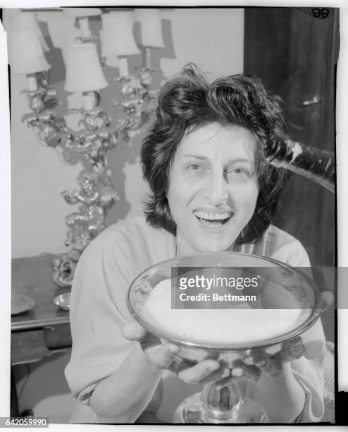 Smiling actress Anna Magnani, a long time favorite of the Italian films, celebrates her victory after winning Hollywood's Academy Award for "Best...