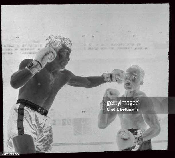 Former welterweight champion Tony Demarco tags lightweight champ Bud Smith with a sharp left in the 2nd round of their scheduled 10-rounder at...