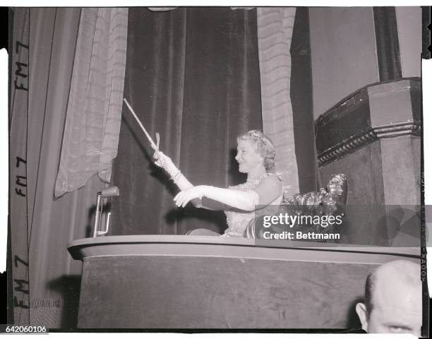 Helen Hayes, First Lady of the American theater, waves her wand from the royal box at the "First Night Ball" in the Waldorf Astoria Hotel last night....