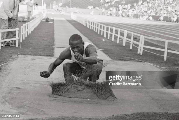 Ralph Boston of Nashville, Tennessee, officially breaking the world's long jump record in the final U.S. Olympic Track and Field Trials is shown with...