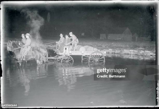 The driver of the wagon, losing his way in the darkness, falls easy captive to the troopers when the wagon rolls into a shallow river.