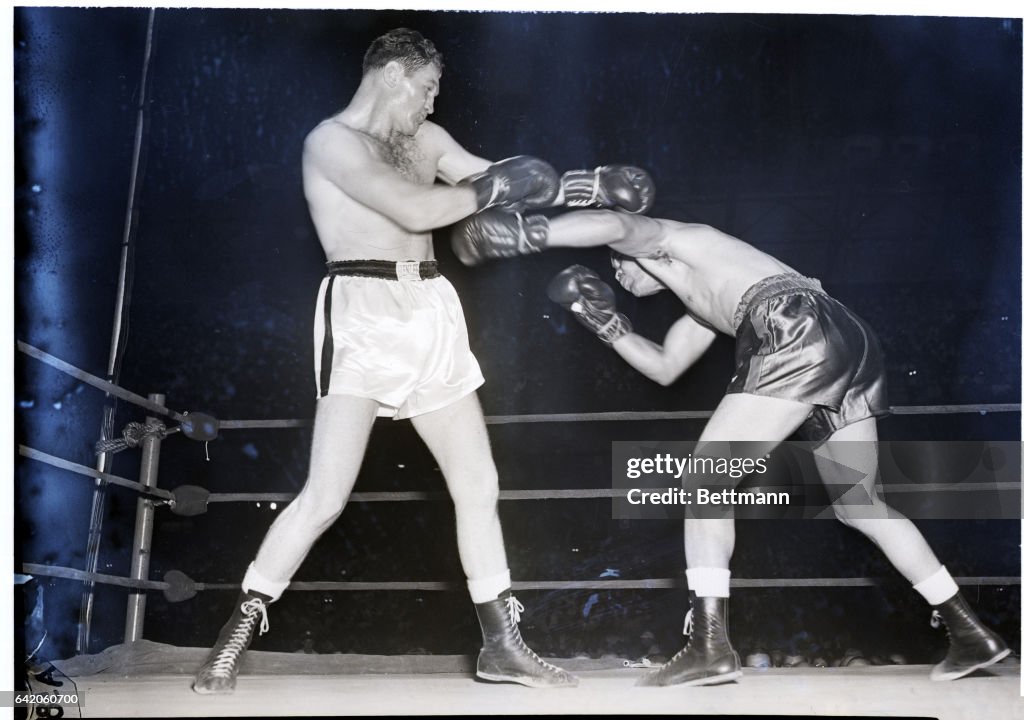 Joe Louis Launches Left at Opponent