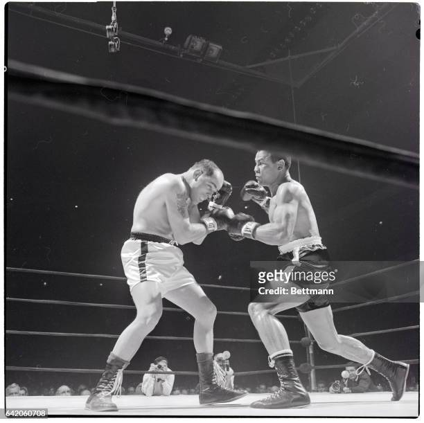 New York, NY- Middleweight slugger Jose Torres of New York rips into veteran Carl "Bobo" Olson prior to scoring a first-round knockout in their...