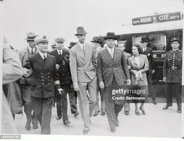 Here to greet millionaire Howard Hughes upon a stop during his flight around the world are, left to right, Commander Girardot of Le Bourget's...