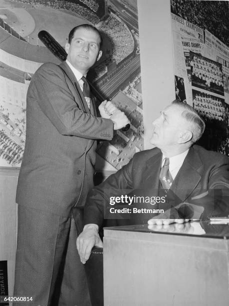 Veteran outfielder Tommy Henrich of the New York Yankees shows manager Casey Stengel how he hopes to duplicate or better last year's .308 average,...
