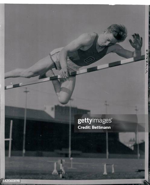 Eugene, Oregon: Les steers shown clearing the bar at 7 feet, 1/2 inch during exhibition before 6,000 persons who gathered to watch Oregon State...