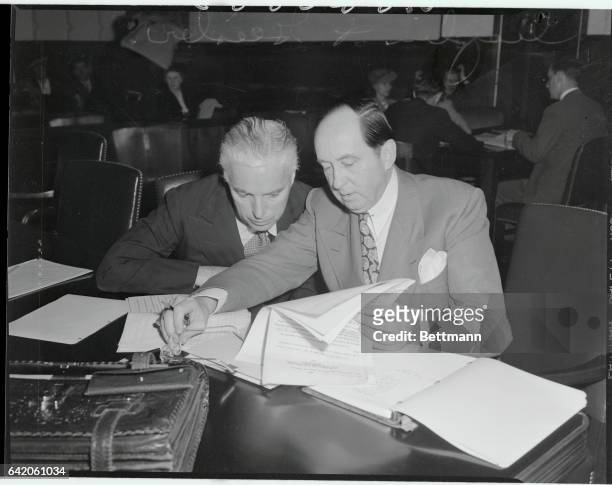 Chaplin and Attorney Confer. Los Angeles, California: Charles Spencer Chaplin and his attorney Jerry Giesler are shown above as they conferred during...