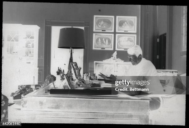 Washington, D.C.: President Ronald Reagan works at a desk in the study of his second floor residence as he gradually resumes the duties of his...