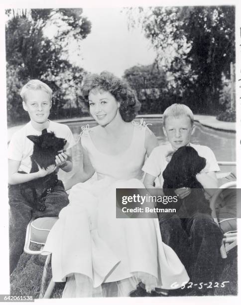 Film star Susan Hayward is flanked by her 9 year old twin sons, Gregory and Timothy, whose custody she was awarded Tuesday after a bitter court...