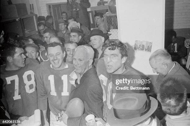 You can almost see Eagle head coach Buck Shaw blushing as quarterback Norm Van Brocklin and Chuck Bednarik plant victiry kisses on him following...