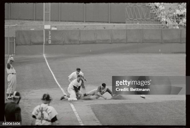 Cincinnati Reds second baseman Pete Rose is out at third base trying to stretch a hit into a triple in the first inning of the Reds-Milwaukee Braves...