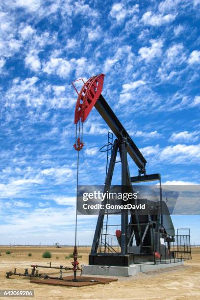 oil pumpjack with clouds in background - lost hills california stock pictures, royalty-free photos & images
