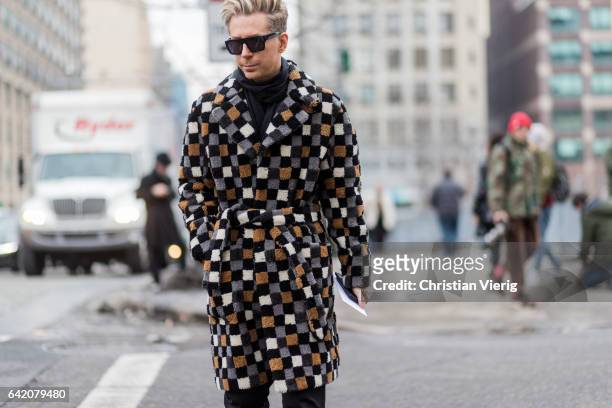 Kyle Anderson wearing a checked coat outside Michael Kors on February 15, 2017 in New York City.