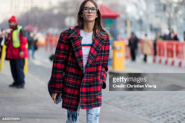 Guest wearing a lumberjack jacket, glasses outside Yeezy Season 5 on February 15, 2017 in New York City.