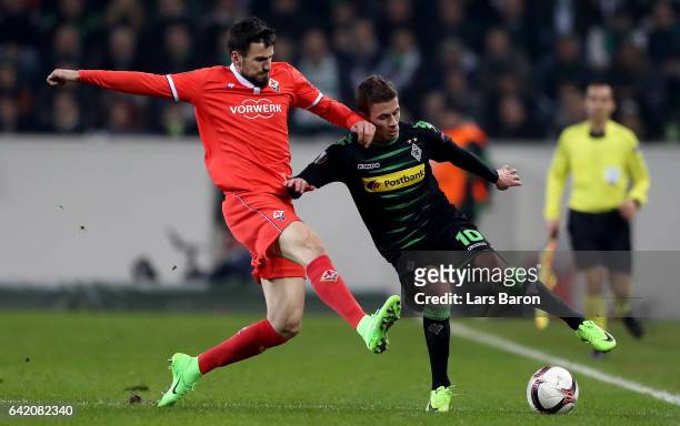 Nenad Tomovic of Fliorentina challenges Thorgan Hazard of Moenchengladbach during the UEFA Europa League Round of 32 first leg match between Borussia...