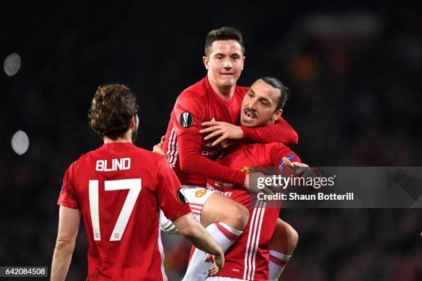 Zlatan Ibrahimovic of Manchester United celebrates scoring his sides first goal with Ander Herrera during the UEFA Europa League Round of 32 first...