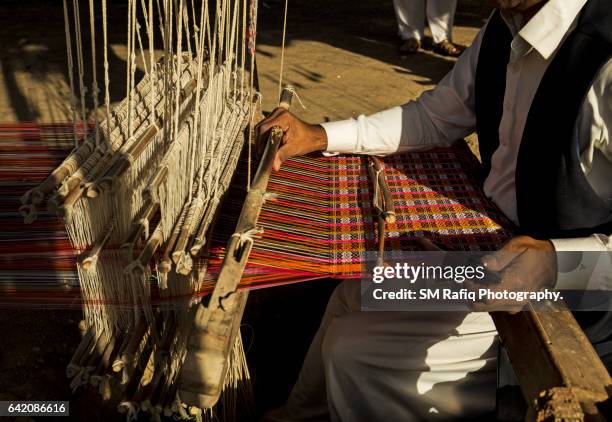 skilled sindhi men are busy producing various kinds of handwoven artifacts - sindhi culture fotografías e imágenes de stock