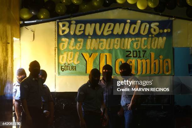 Prison guards wearing balaclavas stand guard at the entrance of the San Francisco Gotera prison, 165 km from San Salvador, on February 16, 2017. In...