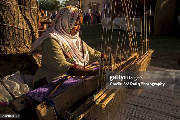 skilled sindhi working women are busy producing various kinds of handwoven artifacts - sindhi culture fotografías e imágenes de stock