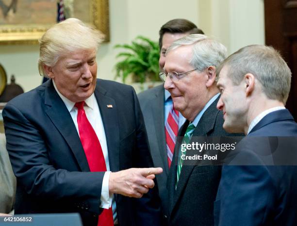 President Donald Trump, left, speaks with US Senate Majority Leader Mitch McConnell , center and US Representative Jim Jordan , right prior to...