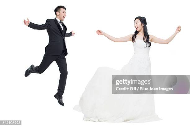 happy bride and groom flying - well dressed couple isolated stock pictures, royalty-free photos & images