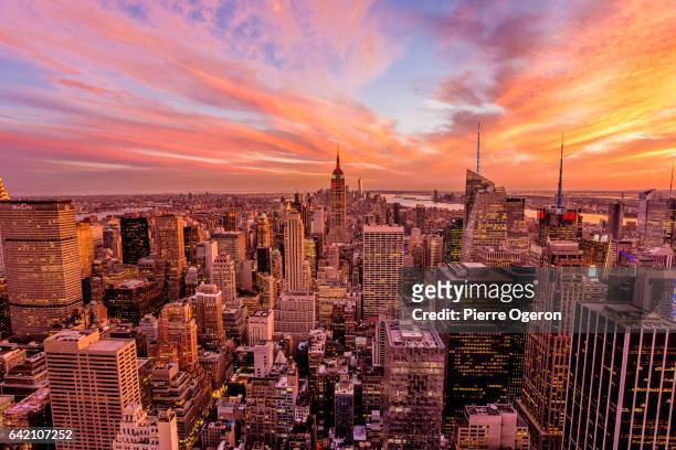 beautiful sunset over manhattan cityscape & empire state building - new york times building stock pictures, royalty-free photos & images