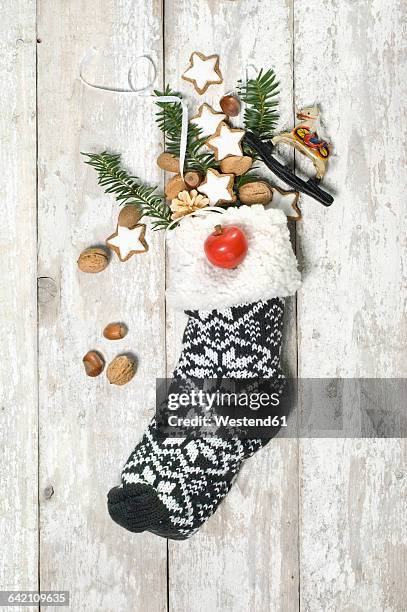 sock filled with cinnamon stars and nuts on st. nicholas day - full stocking stock pictures, royalty-free photos & images