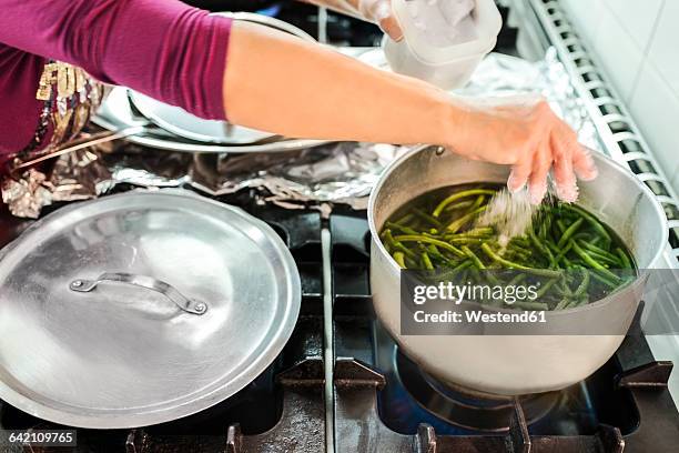 woman boiling green beans in canteen kitchen - green beans stock pictures, royalty-free photos & images