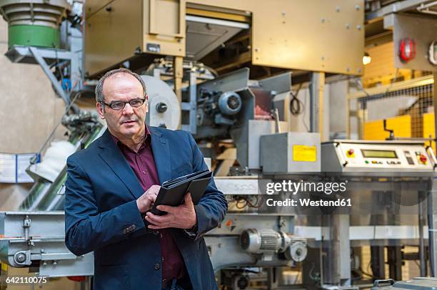 manager checking goods in factory - workflow automation stock pictures, royalty-free photos & images