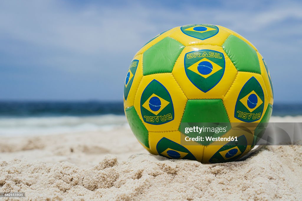 Brazil, Rio de Janeiro, Soccer ball laying on the beach