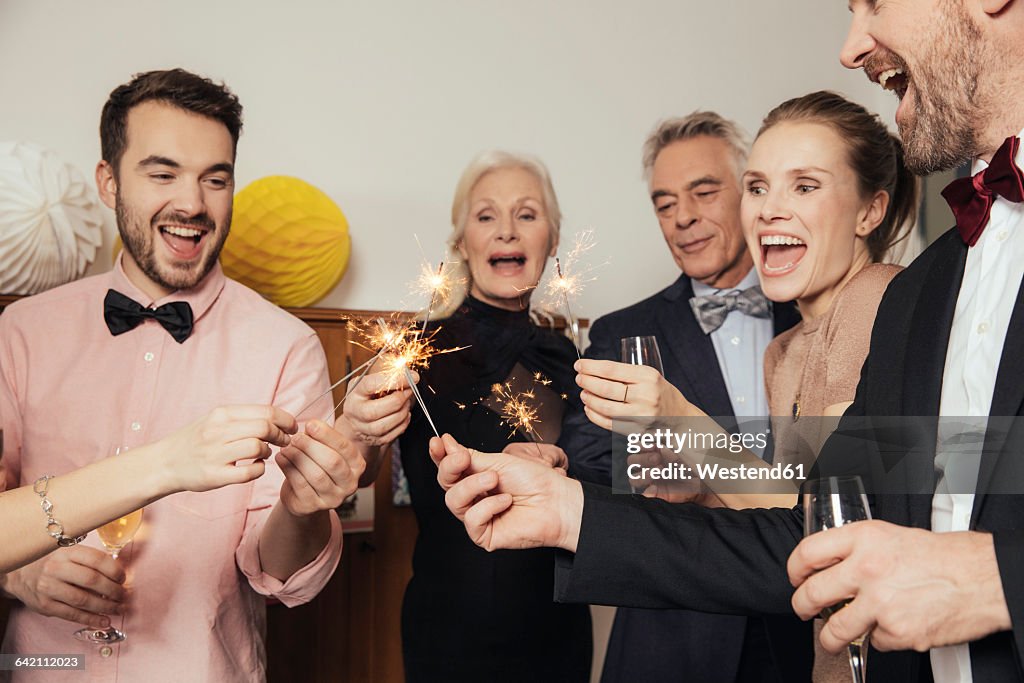 Friends celebrating New Year's Eve together, drinking champagne