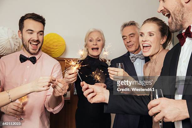 friends celebrating new year's eve together, drinking champagne - 39 year old stockfoto's en -beelden