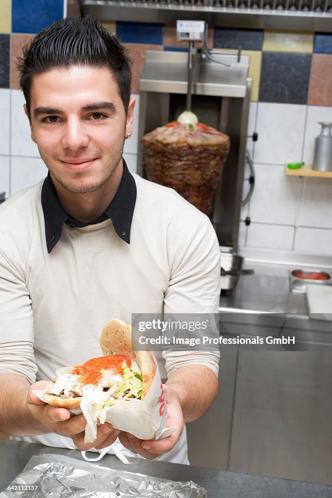 Young chef holding a dner kebab