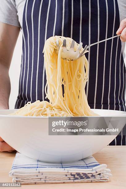 picking up spaghetti with spaghetti server - spaghetti spoon stock pictures, royalty-free photos & images