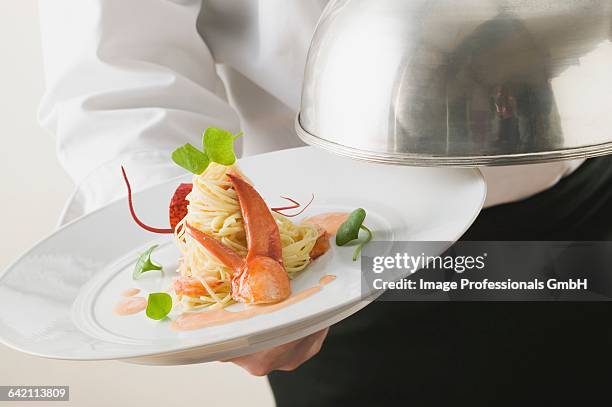 waiter serving linguine with lobster - cloche stock pictures, royalty-free photos & images