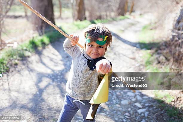 little boy dressed up as a superhero posing on a path - little ballet stock-fotos und bilder