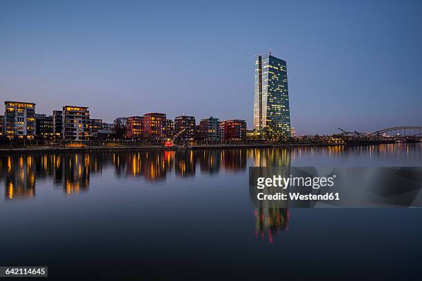 germany, hesse, frankfurt, main river and european central bank headquarters in the evening - ezb stock-fotos und bilder