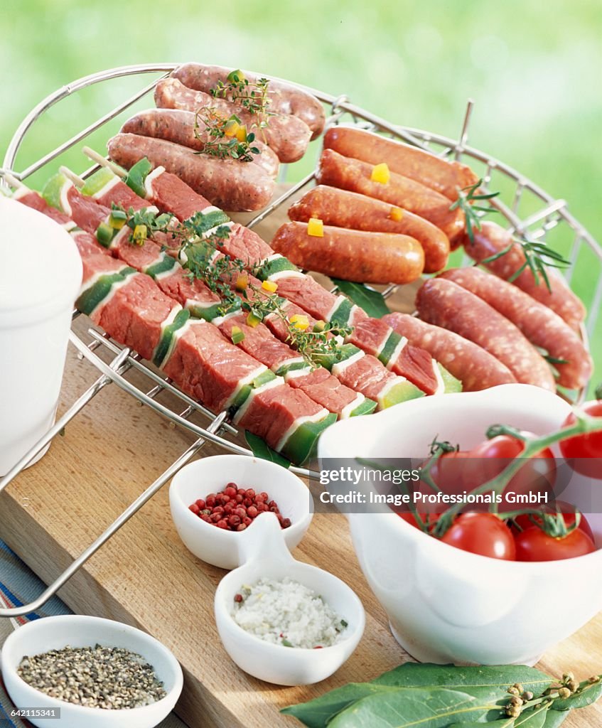 Selection of raw brochettes and mini sausages
